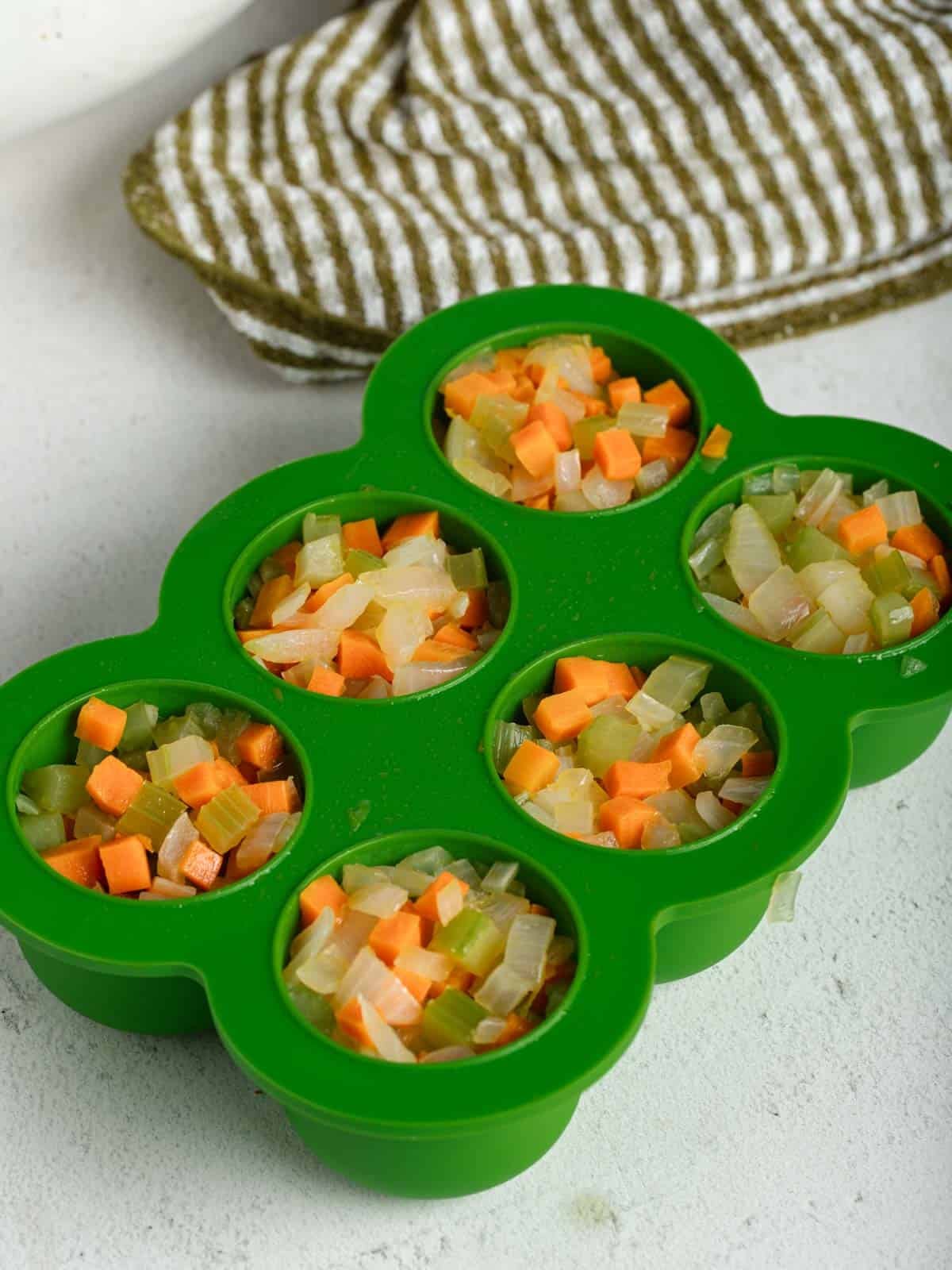 Cooked mirepoix portioned into an ice cube tray.