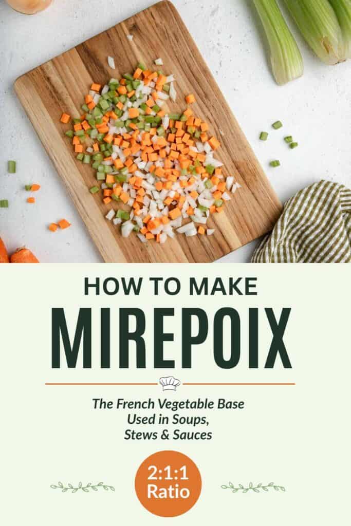 A mixture of diced onions, carrots, and celery scattered on a wooden cutting board.