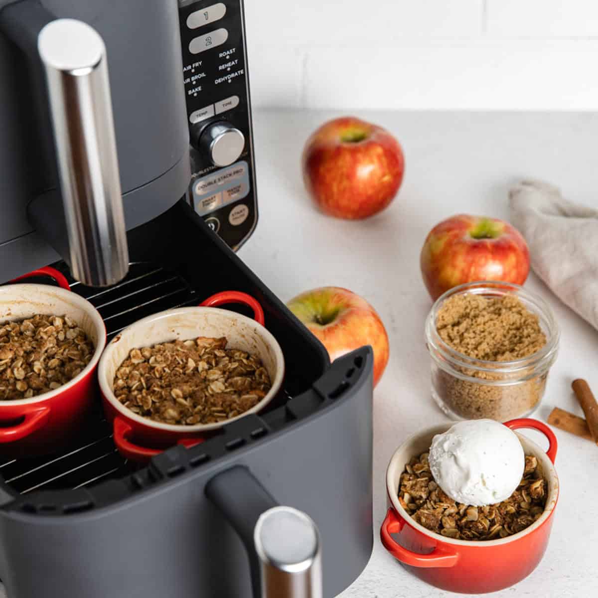 Apple crisp in the air fryer and with a scoop of vanilla ice cream.