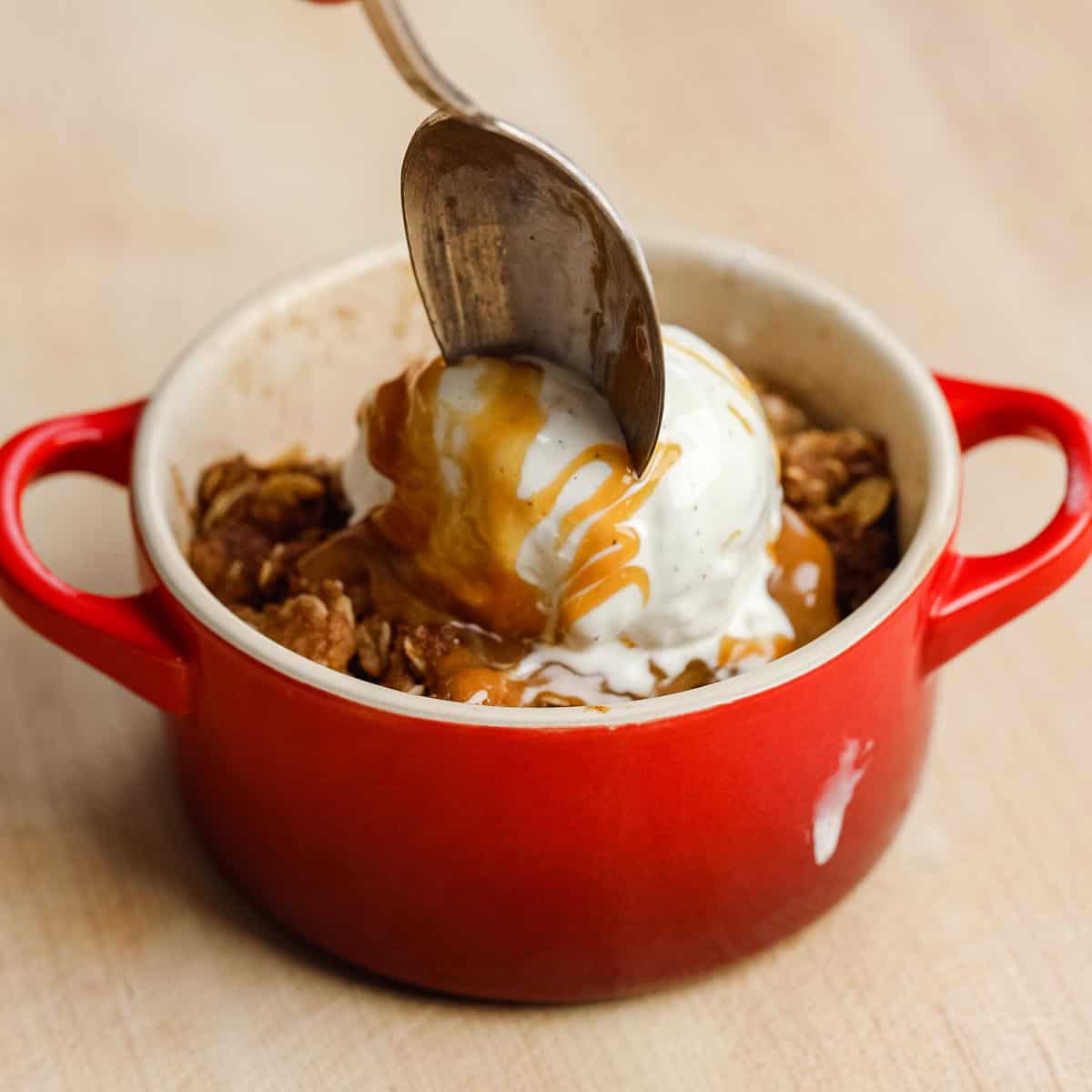 Using a spoon to get a bit of apple crisp.
