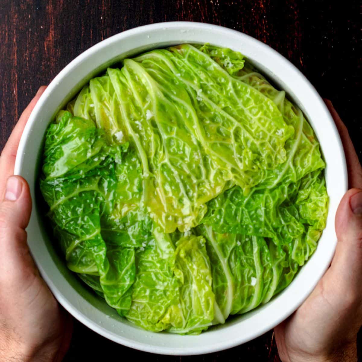Cabbage chou farci inside of a large white ramekin.