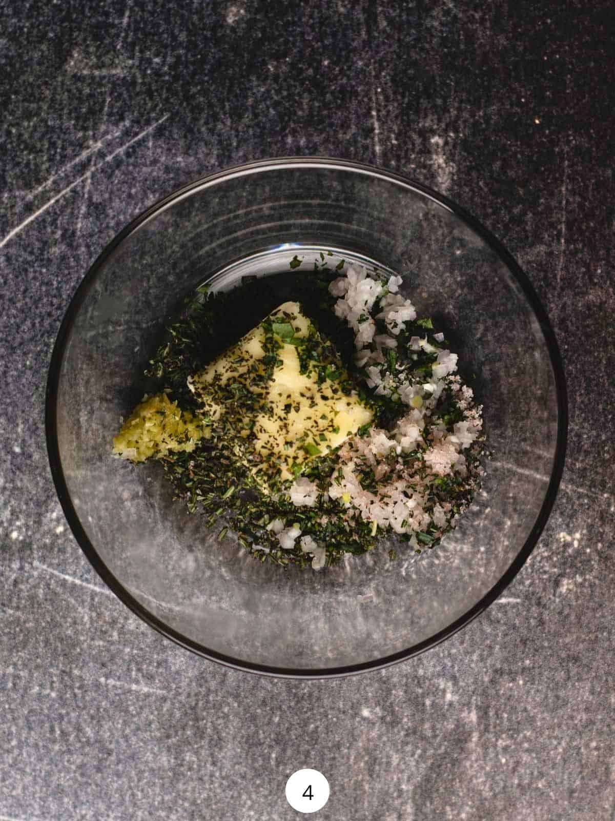 Compound butter ingredient inside of a small glass bowl.