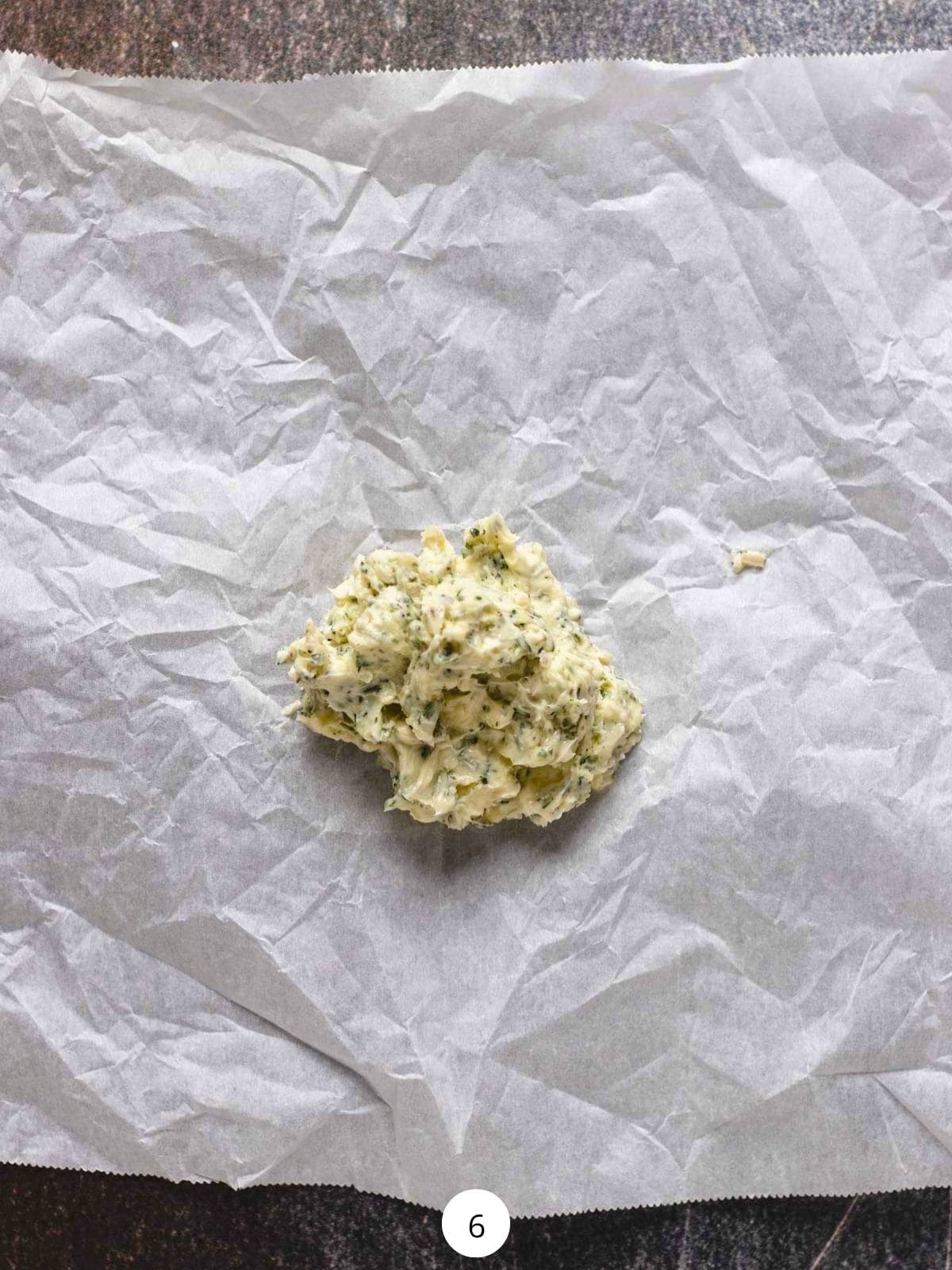 A scoop of compound butter on a piece of parchment paper.